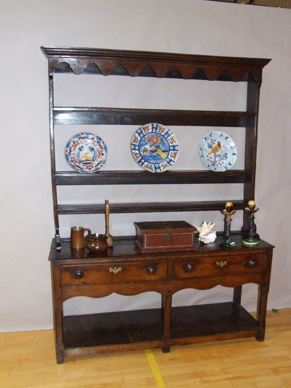 Lovely 18th Century oak Welsh dresser or sideboard with rack, the rack with scalloped frieze over open shelf, the base with two drawers over scalloped apron, over a pot board shelf, great colour and patina overall.
