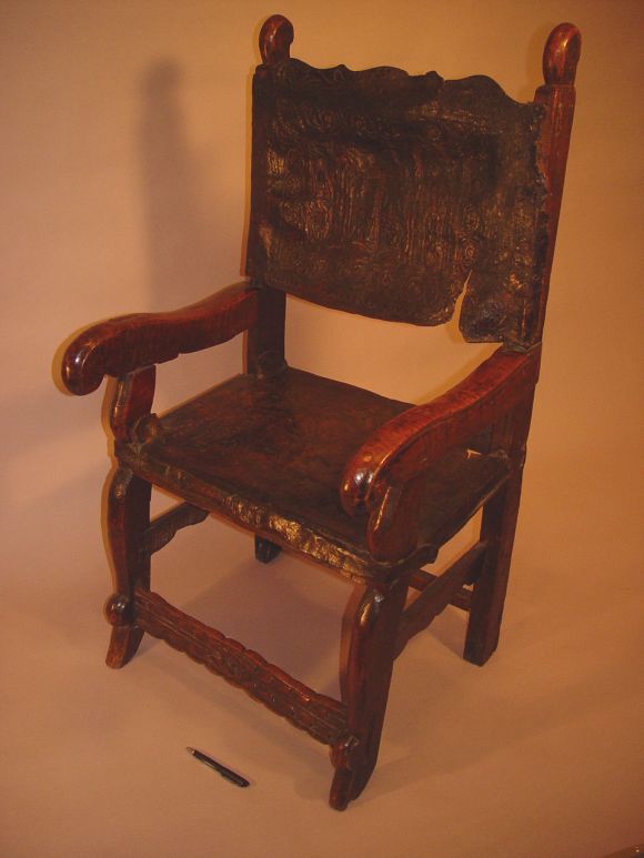 Rare 17th Spanish walnut armchair with original embossed and polychromed leather, excellent colour.