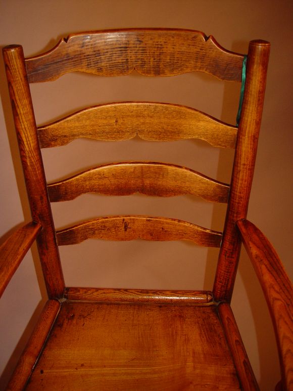 Queen Anne ash ladderback armchair with turned legs ending in pad feet and boldly turned stretcher