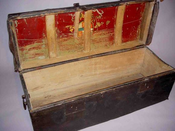 Rare 17th century leather wrapped traveling trunk with its original wrought iron carrying handles and clasp. Original hand-painted coat of arms still retained on interior of lid.