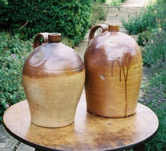 Two mid 19th century English salt glazed stoneware cider jugs with handles.  Good scale.  Note: not a pair.