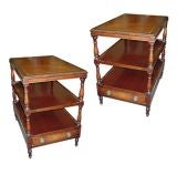 A pair of three-tiered leather-top tables