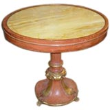 An unusual  polychrome table on hand-carved base