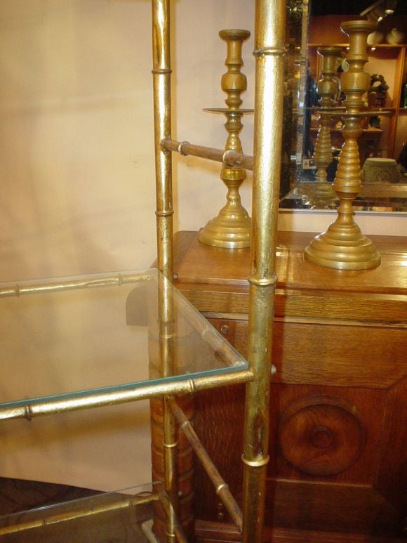 A pair of Gilt-Metal Etageres with Glass Shelves