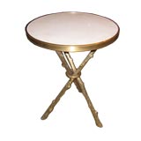 An unusual pair of brass tripod tables