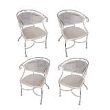 A set of four wrought-iron klismos armchairs