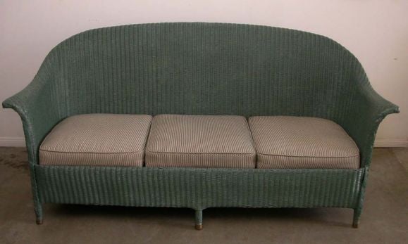 A very useful size. This settee with its sweeping scroll is raised on six legs resting on brass caps. Color is now a blue-green, but may easily be made your color of choice.