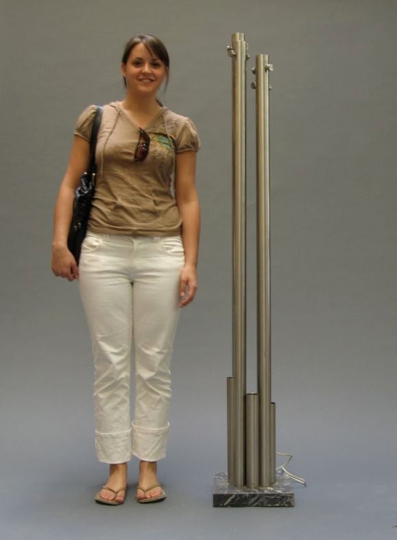 Brushed nickel coatrack with accent light mounted in base. Works well as object when not in use.