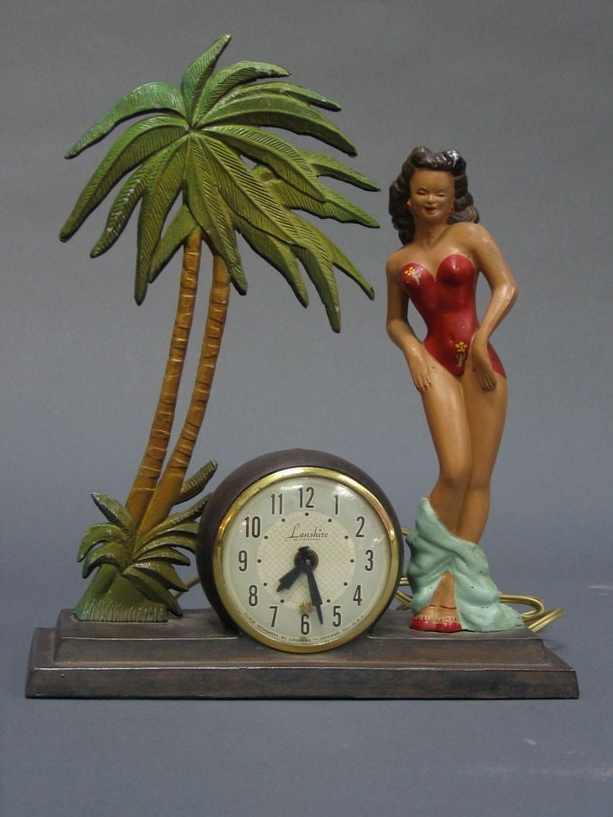 Seldom seen, this clock was sold in souvenir shops in Hawaii and Florida, circa 1948. Risque themed with bathing beauty dropping her towel amid palm trees. Fun thing!