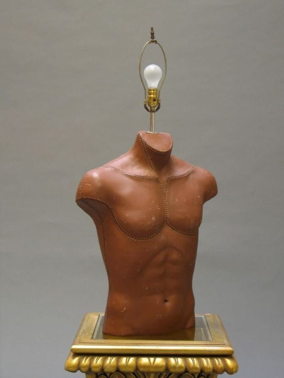 Hard rubber male torso table lamps with surface simulating stitched leather. Available in various heights, some with crotch. Priced separately.