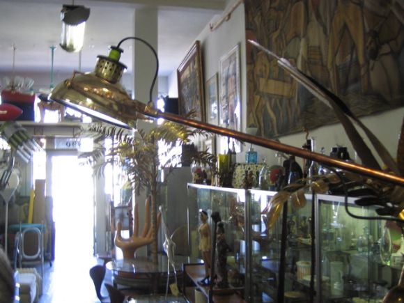 Cantilevered arm with counterweight.  Construction and materials are superb, articulated movement