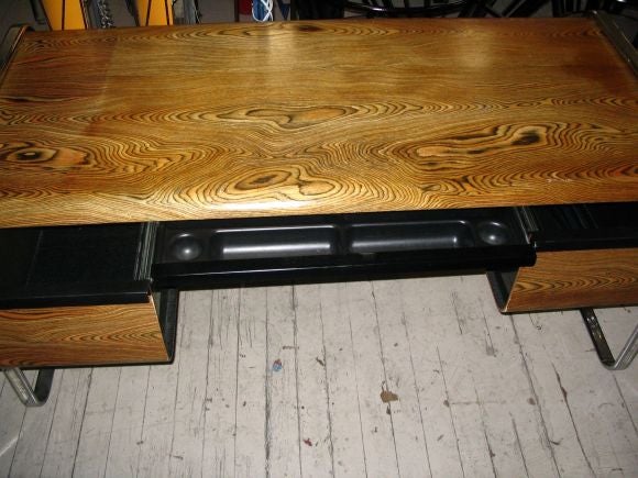 Peter Protzman desk by Herman Miller, c.1970, exotically grained molded plywood top, desk with center drawer and two large drawers on chromed steel base,  signed.