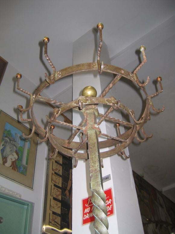 Fabulous hand wrought iron hall tree on casters with removable umbrella trays.  Commanding presence.  Quite heavy.