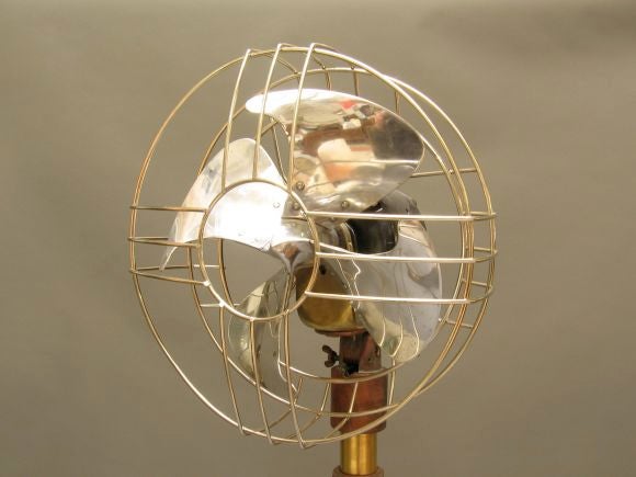 General Electric Fan really moves the air with style. Fan blade itself is a work of art. A hard to find piece.  The fan is mounted on a telescoping stand shown here at it's shortest configuration.
