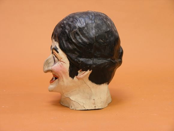 Old Halloween head makes fantastic decorative sculpture. Warm expression on face.