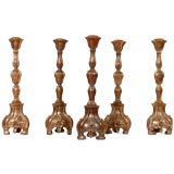 Set of five baroque style carved candlesticks.