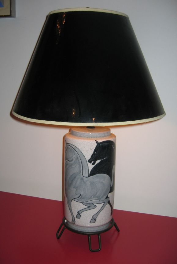 Beautiful pair of matching ceramic lamps with hand-painted stylized equestrian figures. On iron hairpin base. Signed and dated 1953 on bottom of each example.