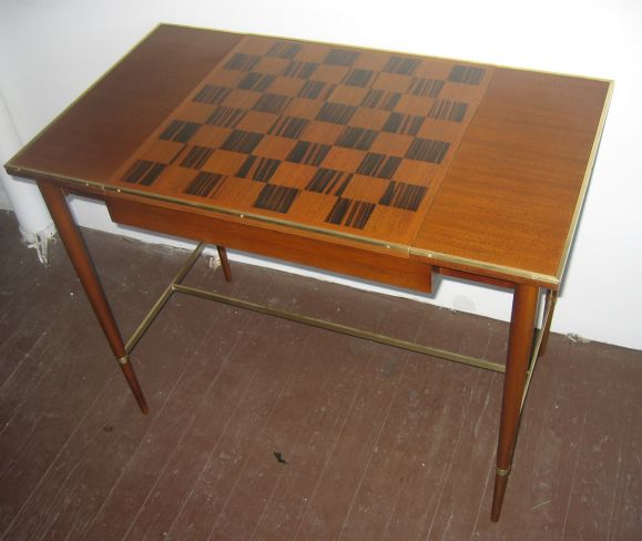 Another elegant McCobb design for Sacks Brothers, in Hondurian Mahogany with a Mahogany and Macassar Ebony chess board center, on brass stretchers.  Center section is finished in mahogany on reverse, and flips over, to transform from game table to