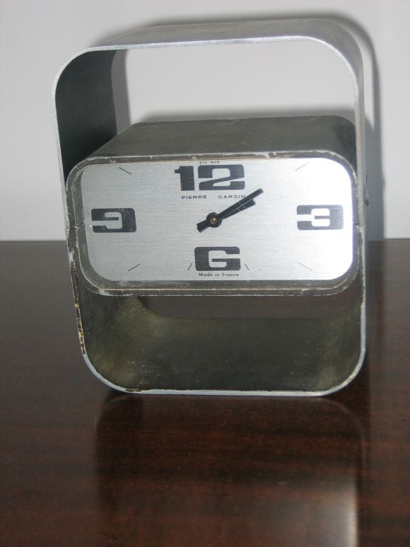 Super-groovy and extremely well made desk clock in heavy cast aluminum, enameled metal, and glass. Textured metal bottom and brushed aluminum top.  Keeps great time.