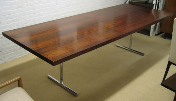 Beautiful table with bookmatched rosewood veneer and chrome legs, distributed by Stendig. A version of this table is in the MOMA permanent design collection. Tres chic!