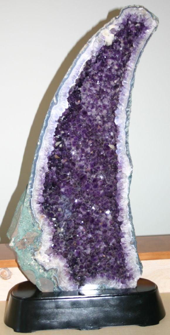 Unbelievable tall, sculptural, quartz crystalline geode on black lacquer base.