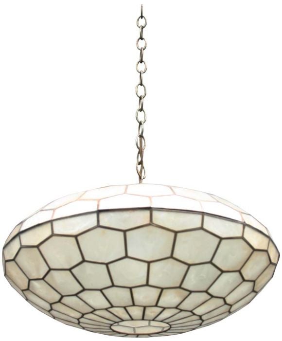 Hanging Capiz shell eliptical pendant with brass hexagon pattern design.