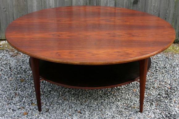 Round, two-tier rosewood coffee table with copper details; magnificent rosewood grain.