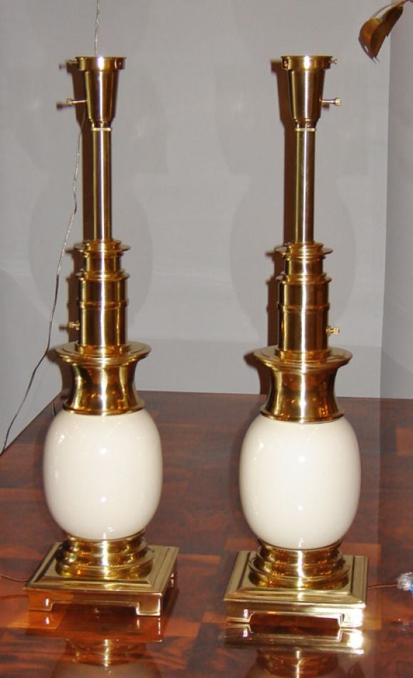 A pair of asian inspired, cast brass table lamps with ceramic ivory 