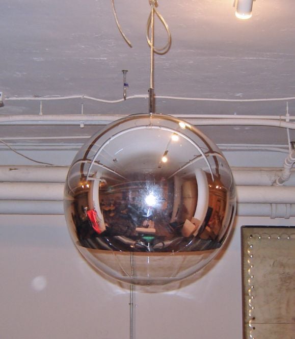 Mirror ball lights designed by Tom Dixon.  Large silver mirrored sphere hangs with single bulb, projects light downwards.  Sold individually.  Eight available.