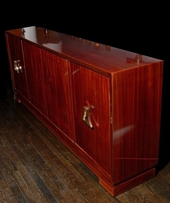 A magnficent flame-mahogany console with solid bronze hardware labeled Grosfeld House. This incredibly designed console features subtle Asian-modern influence and a beautiful custom interior behind four doors. The case of the console is unusually