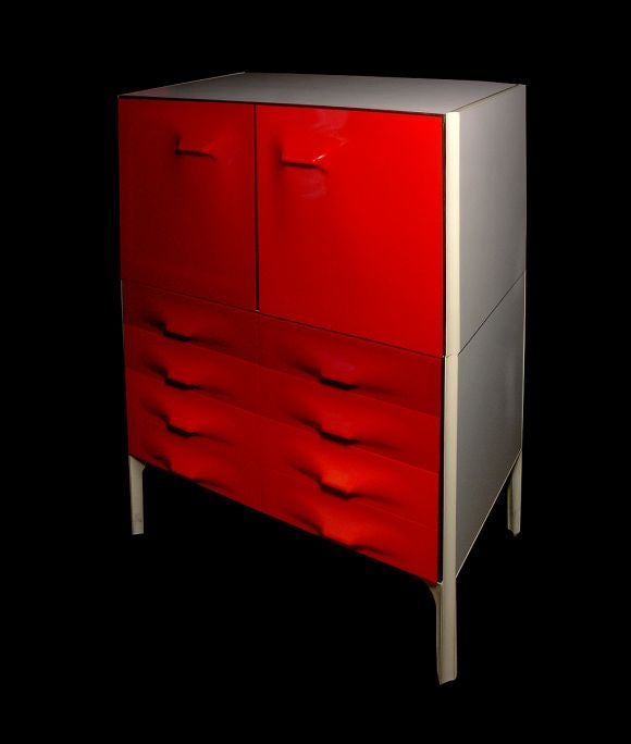A DF-2000 dresser with cabinet Raymond Loewy for Compagnie d'Esthetique Industrielle (C.I.E.), France, Circa 1960. in red to orange molded plastic with white laminate and white enameled metal fittings, interior in rosewood with rosewood backs.