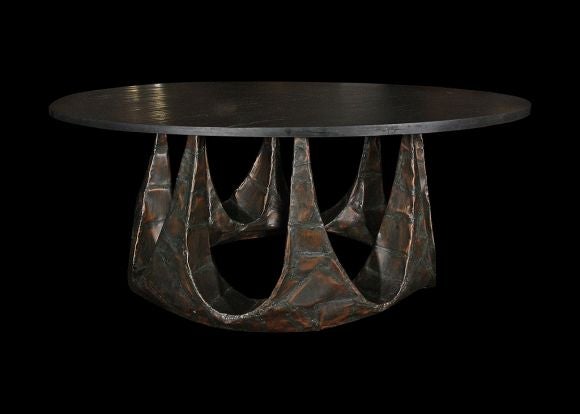 A rare, one of a kind custom dining table by Paul Evans, 1963. Eight organic spires rise from a circular base to support a massive 72 inch round slate top. Welded steel and bronze with a copper / brown patina. From the collection of the original