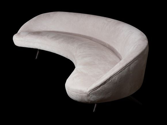 Spectacular crescent shaped Sloane sofa by Vladimir Kagan. Graceful curved sofa seems to float on Kagan's signature carved walnut legs. Newly upholstered in an oyster ultrasuede.