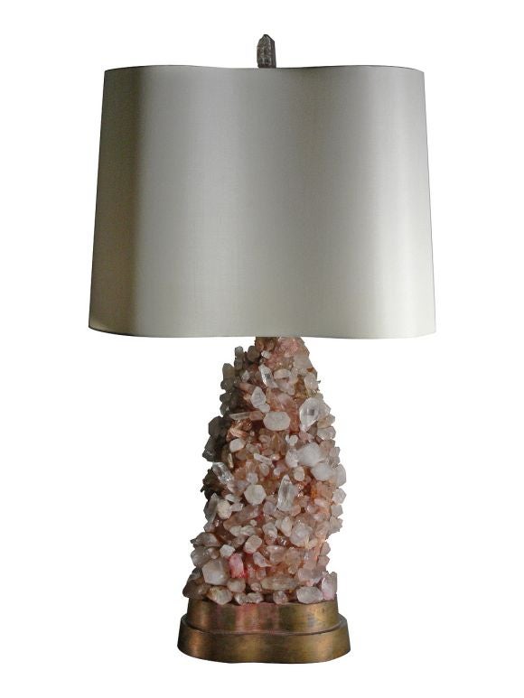 Exquisite pair of rock crystal and amethyst lamps by Carol Stupell, c 1950.  Masses of clear quartz and amethyst specimens are mounted on custom gilt bases. Custom silk laminate shades echo the shape of the base. Amethyst is top quality with little