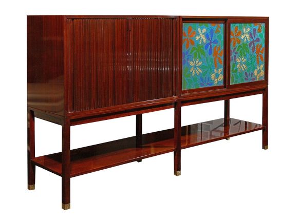 Spectacular console by Harvey Probber. Mahogany case with tambour doors on the left concealing an adjustable shelf. Right side with two sliding, enameled copper panels in a Matisse inspired abstract floral design. Case on an elevated stand wth an