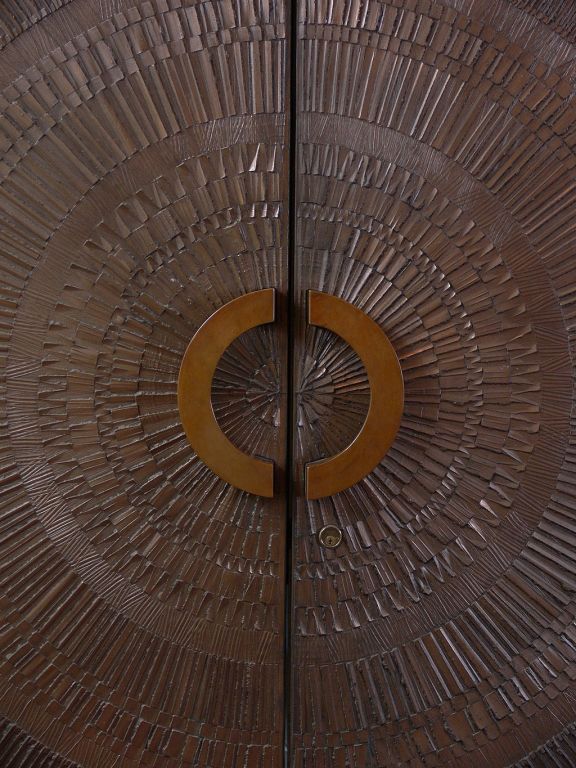 Magnificent, over scale doors by Billy Joe McCarroll, in collaboration with David Gillespe. Cast, bronzed resin in a radiant pattern adorn both sides of these doors. Deeply incised lines and finely modeled details exhibit highest quality precision