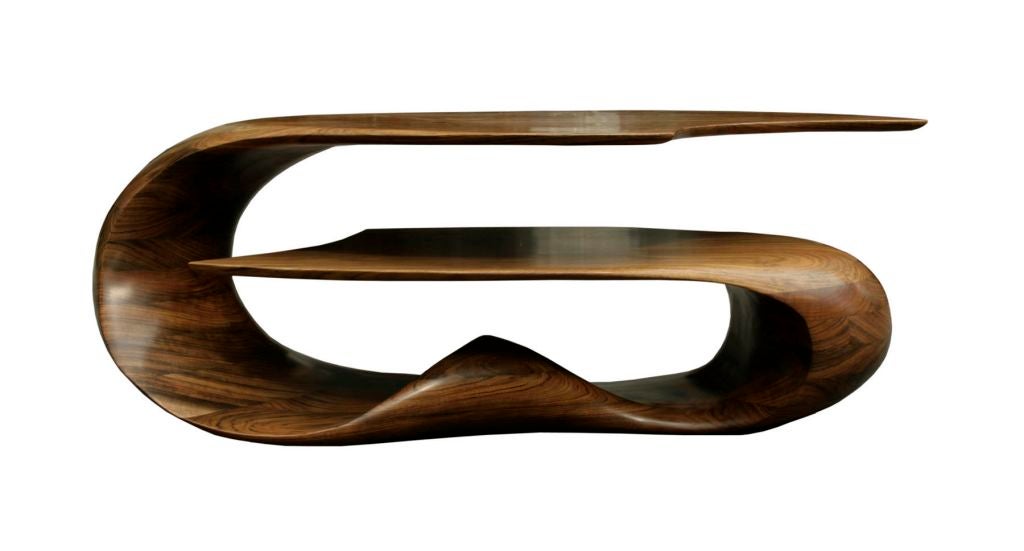 Riptide table in African Mozambique by Michael Coffey. Double leaf coffee table has two surfaces that fold into one another leaving slices of space in between. Coffey plays with ebbs and flows of form and balances visual weight with negative space