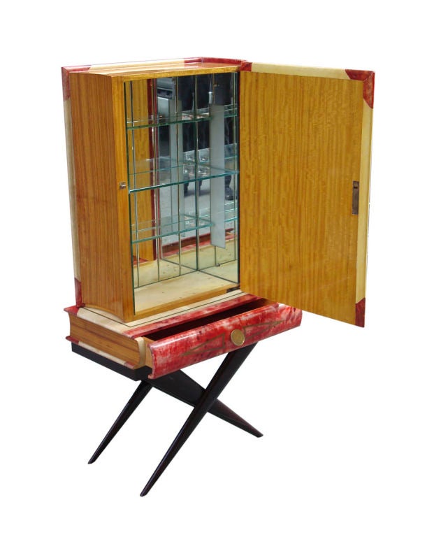 Incredible trompe l’oeil bar by Aldo Tura. Lacquered goatskin book form bar painted with a partial reproduction of Breugel’s “Peasant Dance”. Case in ivory and red lacquered goatskin with mahogany “pages”. Single drawer with coin pull. Rests on an