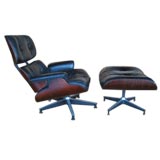 A Leather and Rosewood Lounge Chair and Ottoman by C.Eames