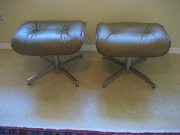 A pair of chromed metal, walnut and leatherette ottomans by Selig, 1960's.