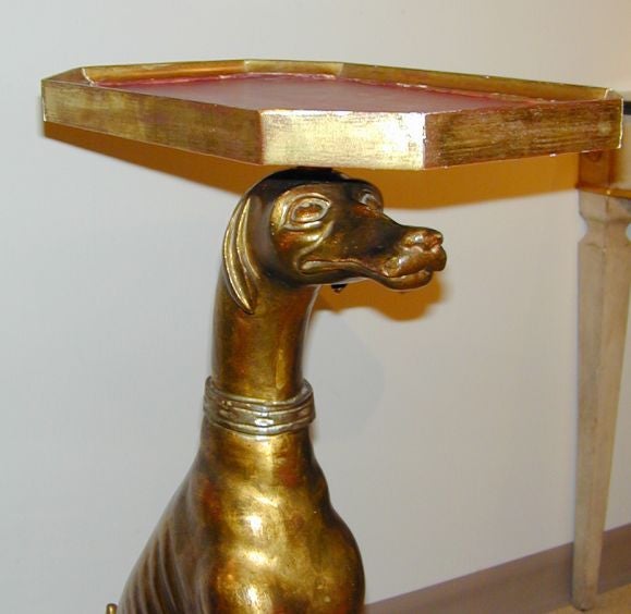 Pair of wonderfully expressive carved greyhound form occassional tables, giltwood on red painted and silver gilt bases.