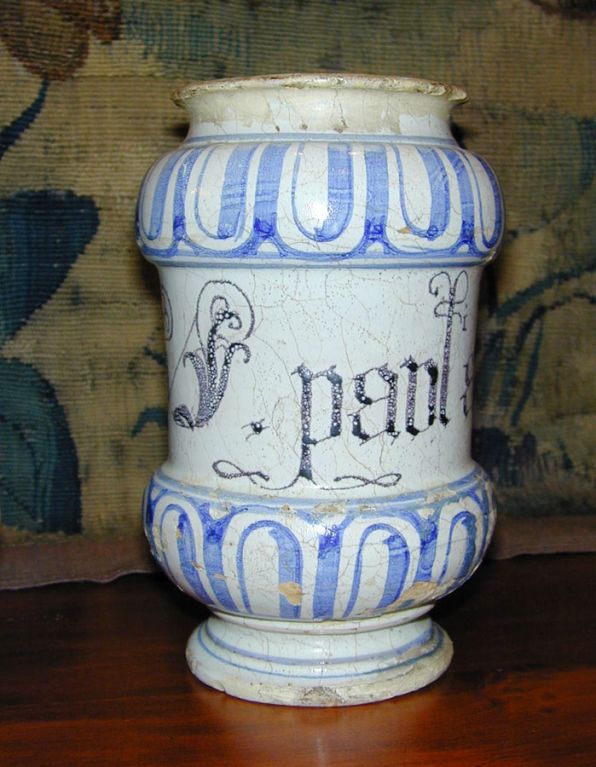 A near pair of 18th century Italian apothecary jars from Savona, decorated in blue and white with mock gadrooning with the name of the potion written in gothic script.   The first is labeled BORAGIN and the second, which is difficult to decipher, is