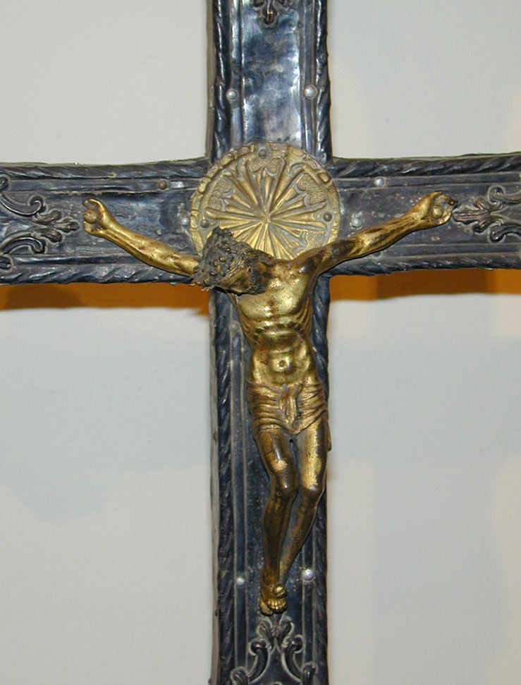 17th century Italian silvered and gilt brass repousse crucifix on a contemporary stand