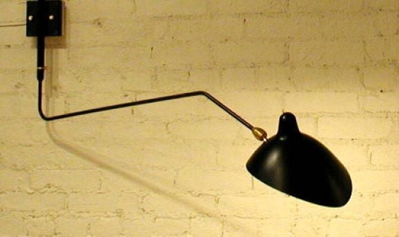 Licensed edition from Serge Mouille's original design, created in 1952.<br />
<br />
Both stylish and practical, it can be used in many different design applications. The shade tilts and revolves on a brass fitting while the arm swings, providing