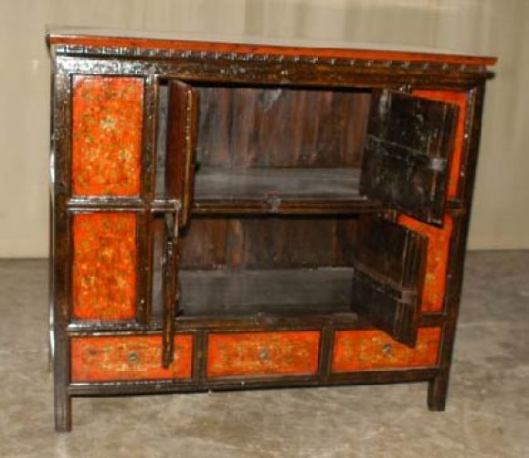 A stunning painted Tibetan chest, fine floral motif on the front side, two pairs of doors and three drawers. View our website at: www.greenwichorientalantiques.com for additional 