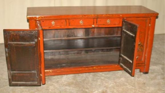 A stunning red lacquer sideboard, framed top supported by straight legs and joined by a pair of bi-fold doors, brass fitting and fine hand painted landscape motif in gold gilt. View our website at: www.greenwichorientalantiques.com for additional