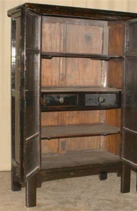 A refined and elegant black lacquer armoire with gold gilt butterfly motif, brass fitting, beautiful color, form and lines. View our website at: www.greenwichorientalantiques.com for additional armoire selections.