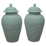 A Pair Of White Porcelain Jars With Covers
