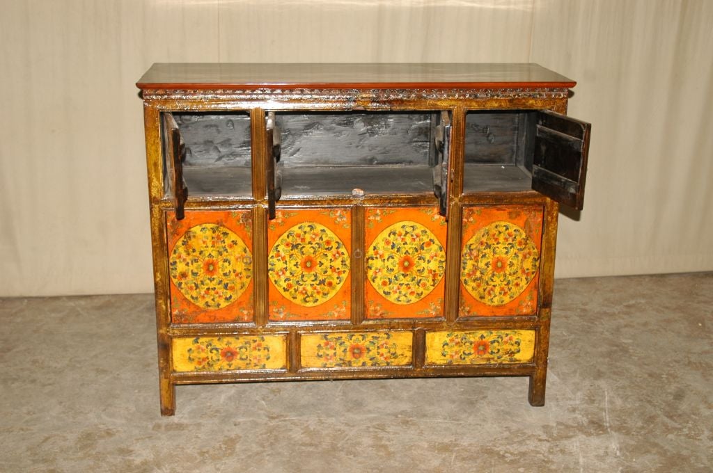 a simple formed and stunningly painted Tibetan chest, open doors on top and middle level, fine painted floral motif in gouache. View our website at: www.greenwichorientalantiques.com for addtional 
