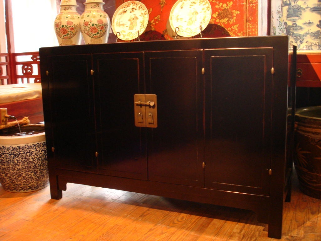 a very refined and elegant black lacquer sideboard, a pair of bi-fold doors with brass fitting. View our website at: www.greenwichorientalantiques.com for additional sideboard selections.
